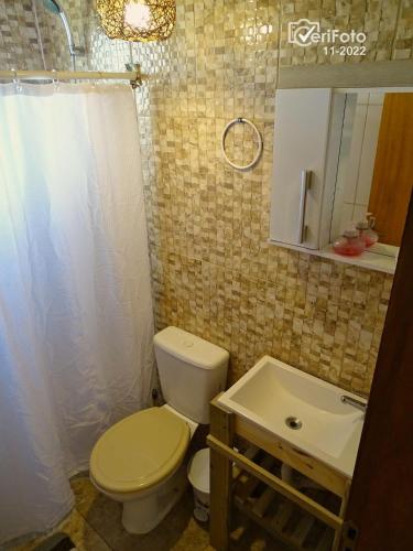 a bathroom with a toilet and a sink at Un Sueño in Punta Del Diablo