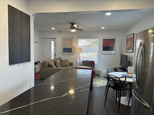 a kitchen and living room with a large counter top at Modern Ranch near Knapp Center, Downtown in Des Moines