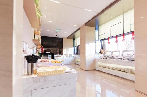 a store lobby with a counter with food on it at Zenith Hotel-Near Train Station & The Mixc in Xiamen