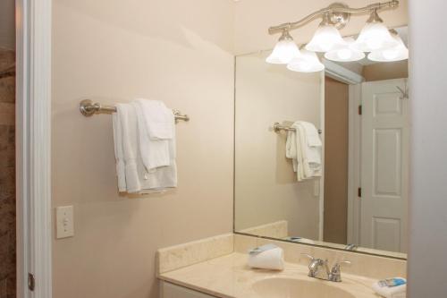 a bathroom with a sink and a mirror at Inn at Camachee Harbor Deluxe 19 in Saint Augustine