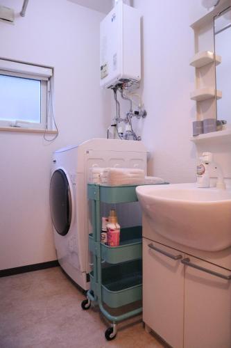 a bathroom with a washing machine and a sink at pier21 in Hakodate