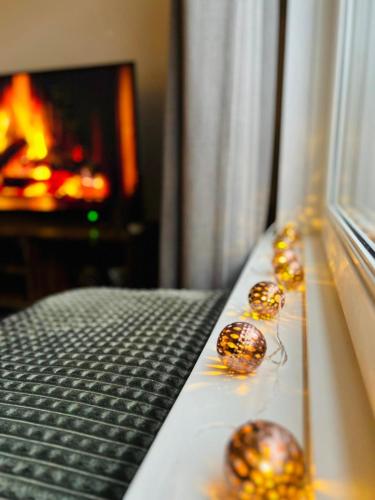 a room with christmas balls on a bed with a fireplace at Bella's Place in Breda