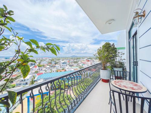 a balcony with chairs and a view of a city at Lam's Beach Homestay in Phan Thiet