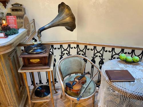 a lamp sitting on a chair next to a table at Villa Flavia Heritage Boutique Hotel in Plovdiv