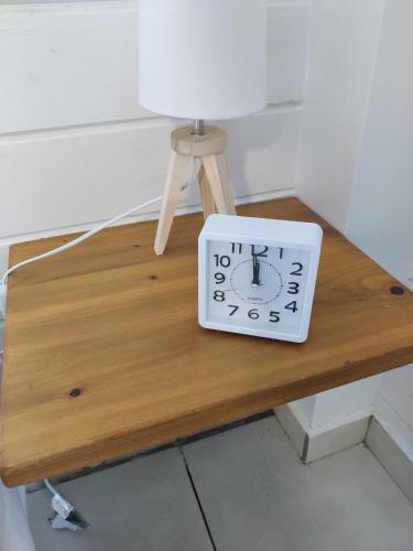 a clock sitting on top of a wooden table at Keshy island colibri in Baillif