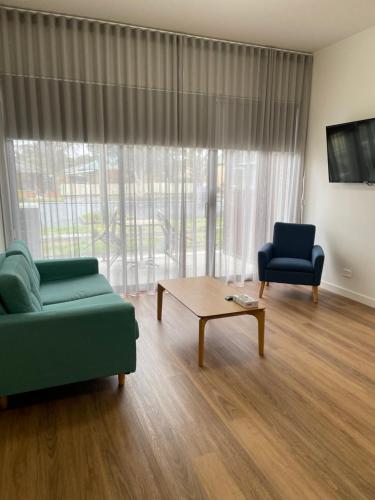 a living room with a couch and a coffee table at Whittlesea Motel in Whittlesea