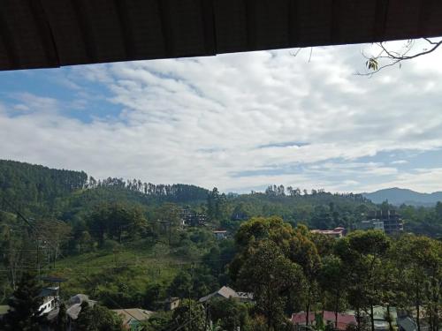 a view of a valley with trees and buildings at The Rock Face in Ella