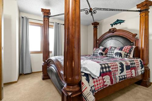 a bed with a wooden frame in a room at Alaskan WolfDen Close to airport centrally located in Anchorage