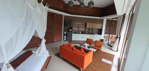 an overhead view of a living room with an orange couch at Cahaya Indah Villas in Ubud