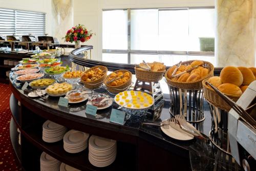 a buffet of food on a table in a restaurant at Mithrin Hotel Halong in Ha Long
