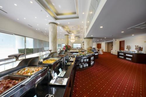 a buffet line of food in a hotel cafeteria at Mithrin Hotel Halong in Ha Long