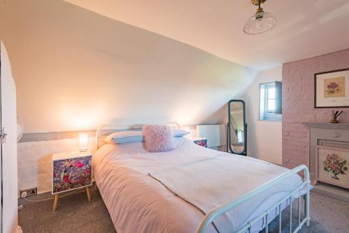 a bedroom with a bed and a fireplace at Raspberry Cottage by Bloom Stays in Great Mongeham