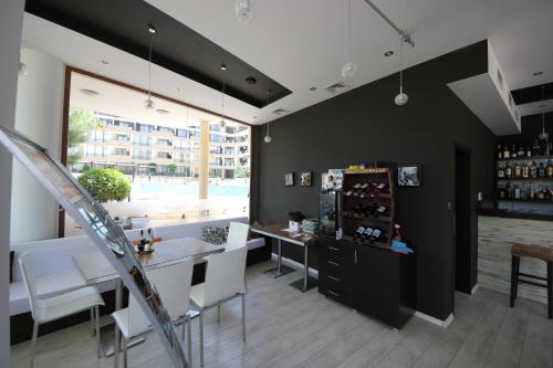 a bar with a table and chairs in a room at Menada Luxor Apartments in Sveti Vlas