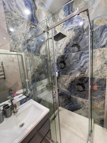 a bathroom with a shower and a sink at Covent Garden in Tashkent
