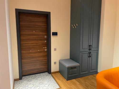 a hallway with a door and a stool next to it at Covent Garden in Tashkent