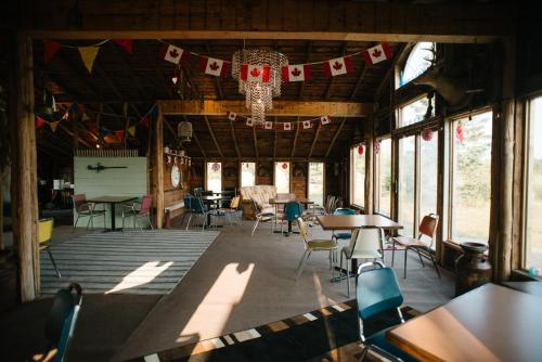 a dining room with tables and chairs and a chandelier at Character farmhouse set in beautiful countryside in Saskatoon