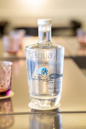 a bottle of alcohol sitting on top of a table at Apulia Praia Hotel in Esposende
