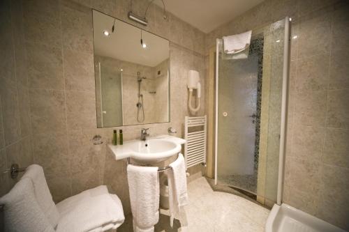 a bathroom with a sink and a shower at Villa Pitiana in Donnini