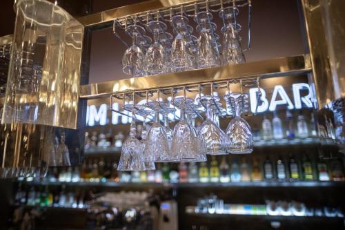 a bar with many glasses and bottles of alcohol at Grand Majestic Hotel Prague in Prague