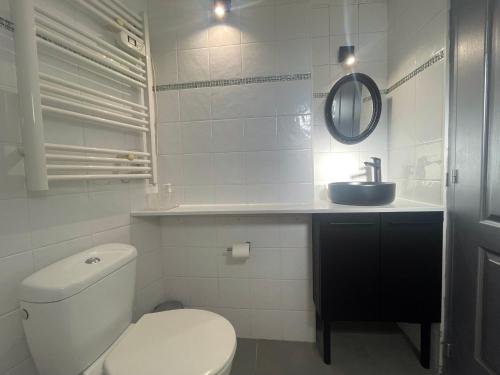 a white bathroom with a toilet and a sink at SOPHIES HOMES VILLA PANORAMIC SEA VIEW and POOL in Mandelieu-la-Napoule