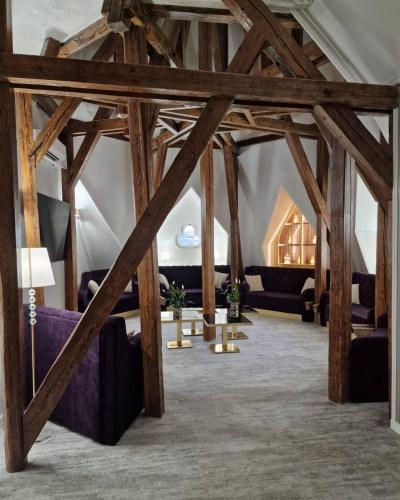a room with wooden beams and couches in a building at Queen Palace in Novi Sad