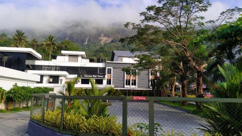 a view of a building with a mountain in the background at VEETEE MID TOWN in Kallar Vattiyar