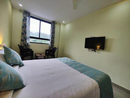 Postel nebo postele na pokoji v ubytování Munnar BnB