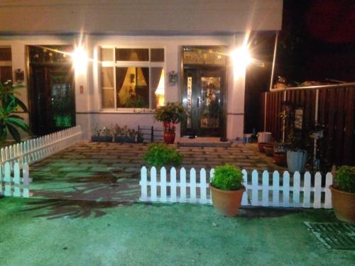 a white picket fence in front of a house at Happy Places in Yuanlin