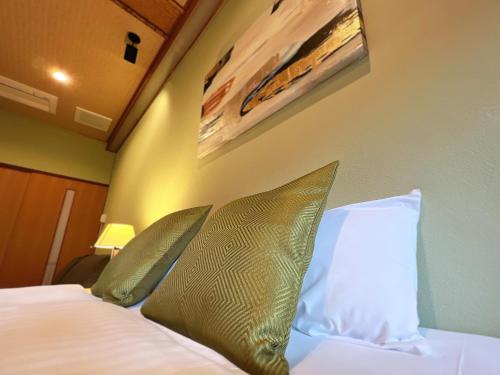 Postel nebo postele na pokoji v ubytování OWL RESORT ARIFUKU ONSEN