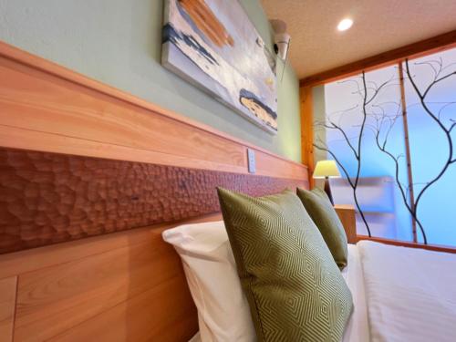 Postel nebo postele na pokoji v ubytování OWL RESORT ARIFUKU ONSEN
