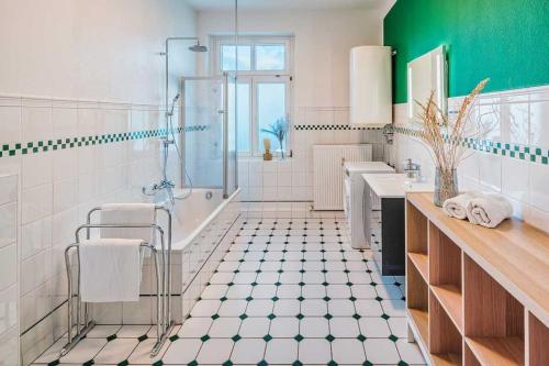 a bathroom with a tub and a sink and a shower at cozy Apartment -Kerner- in Meißen mit MagentaPlus in Meißen