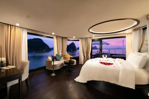 a bedroom with a bed and a large window at Hermes Cruises in Ha Long