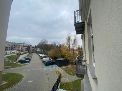 a balcony of a building with a parking lot at TALIA Apartament Tatarska 4 in Przemyśl