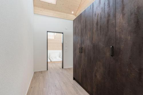 a large wooden door in a room with a bedroom at Melchtal Resort Apart Hotel in Melchtal