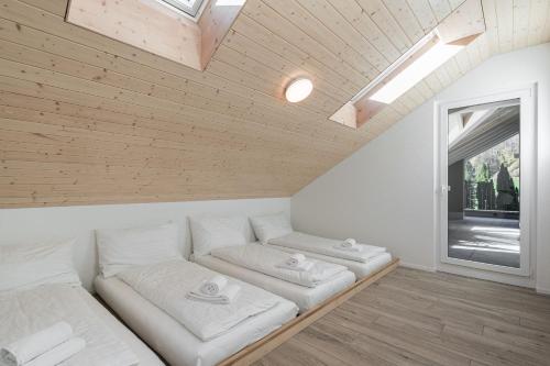 a living room with a white couch and a window at Melchtal Resort Apart Hotel in Melchtal