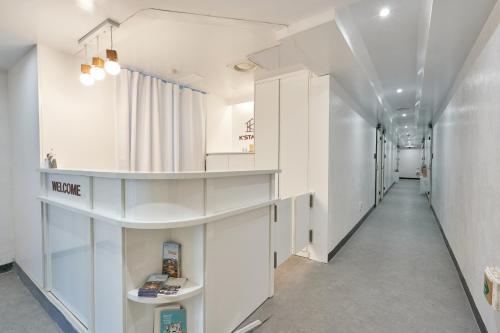 a corridor of a building with white walls and ceilings at K'STAY Sinchon in Seoul