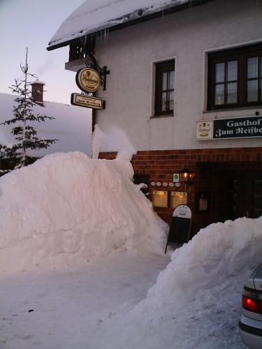 a pile of snow in front of a building at Gasthof 'Zum Reifberg' in Ilmenau
