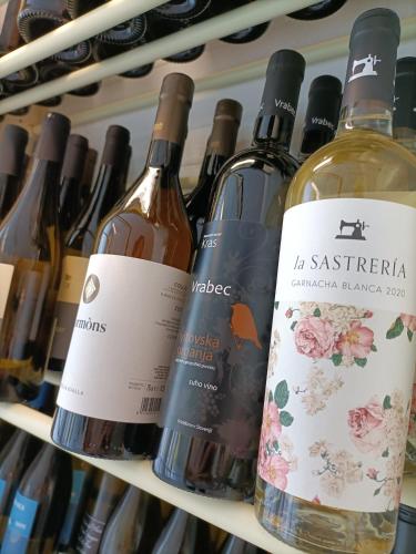 a bunch of bottles of wine on a shelf at Hotel Ai Pini in Grado