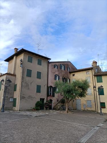 a group of three buildings in a parking lot at Hotel Ai Pini in Grado