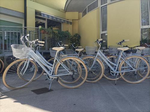 a group of bikes parked next to a building at Hotel Ai Pini in Grado