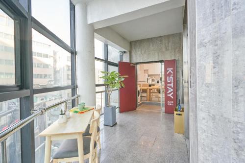 a room with a table and some windows at K'STAY Sinchon in Seoul