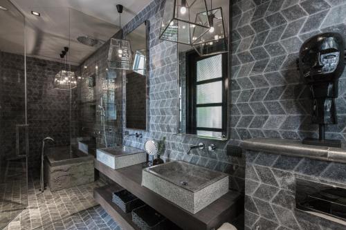 a bathroom with two sinks and a shower at Clay Beach Samui - Beachfront Villas in Amphoe Koh Samui