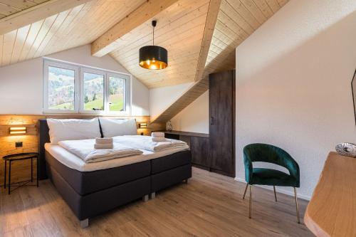 a bedroom with a bed and a table and a chair at Melchtal Resort Apart Hotel in Melchtal