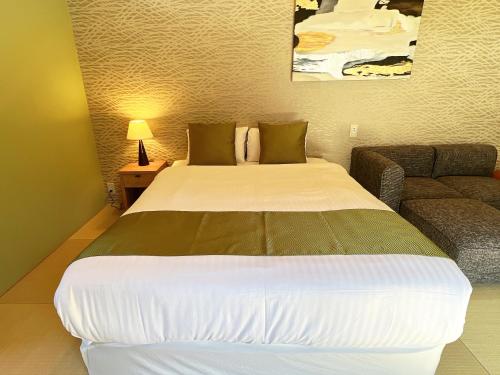 Postel nebo postele na pokoji v ubytování OWL RESORT ARIFUKU ONSEN