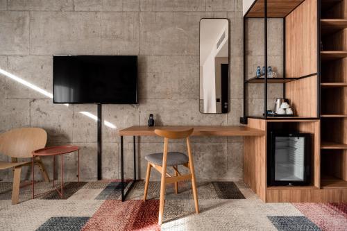 a room with a table and two chairs and a tv at Forest Hotel in Kraków
