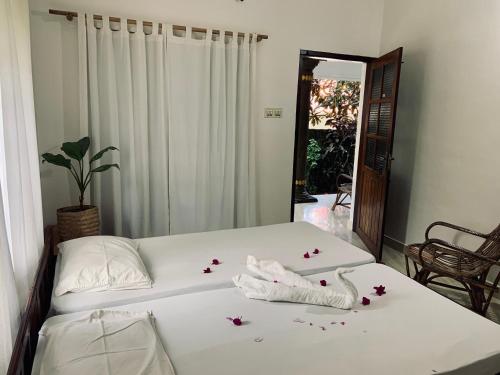 a bedroom with a bed with flowers on it at Green Garden Ayurvedic Resort & Green House in Varkala