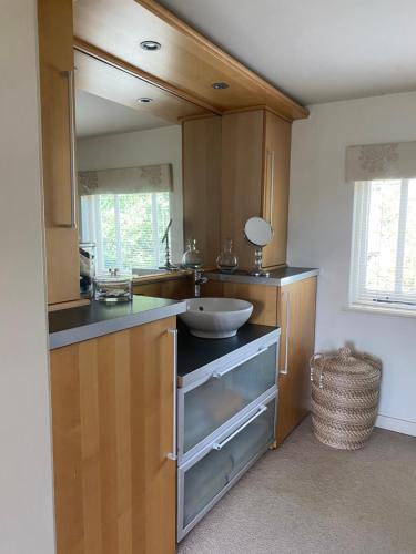 a kitchen with a sink and a counter top at Luxury Country Cottage in Smeeth