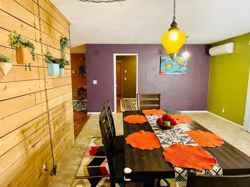 a dining room with a wooden table and a purple wall at Colorful 50's Ranch in the Heart of Eugene in Eugene