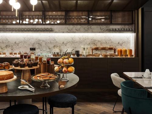 a restaurant with a table with food on it at Mercure Hôtel Le Touquet in Le Touquet-Paris-Plage