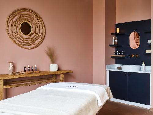 a bedroom with a white bed and a sink at Mercure Hôtel Le Touquet in Le Touquet-Paris-Plage